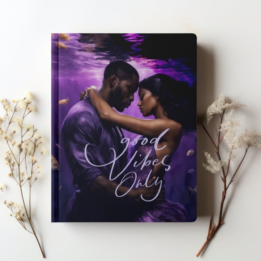 A beautiful Couple dressed in a purple suit and dress under water in a loving embrace with the words "Good vibes only"